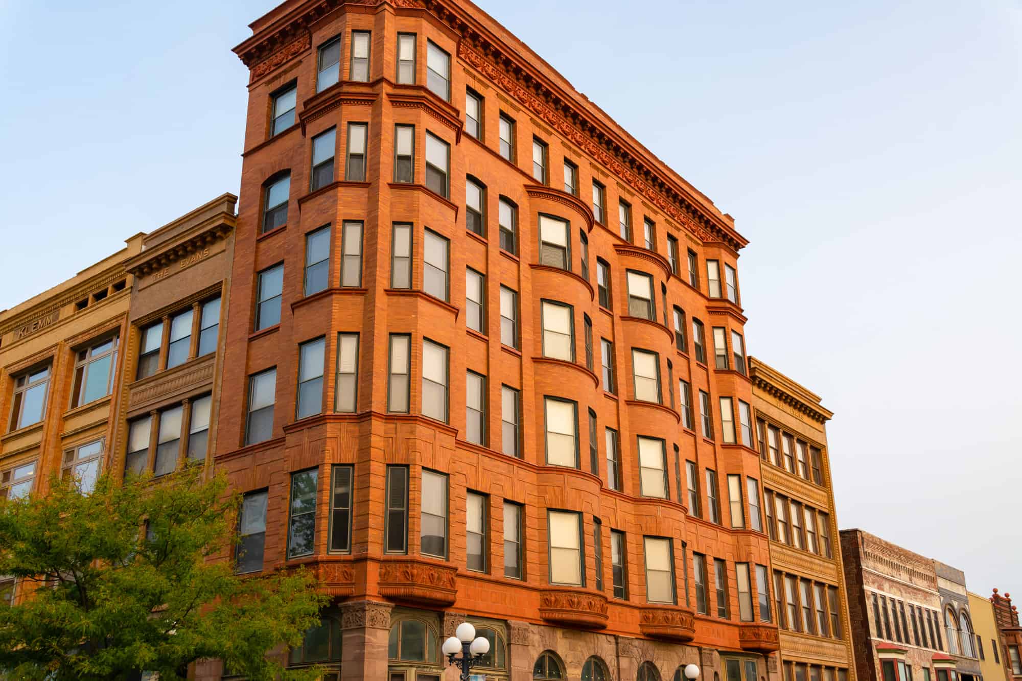 a brick building with tons of windows in sunset golden light in bloomington, if you are visiting the breweries in bloomington, il, make sure to take some time to check out the old buildings and popular attractions in the area as well