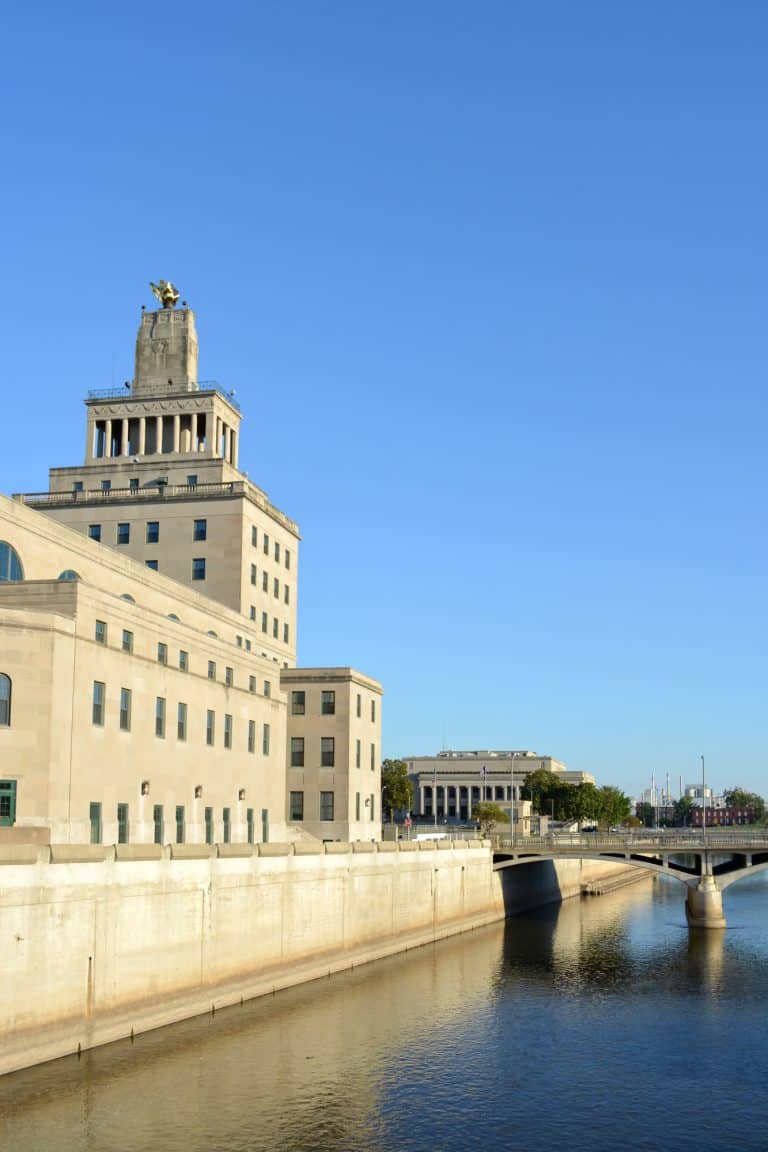 the old city hall stands along the waterfront in front of the river