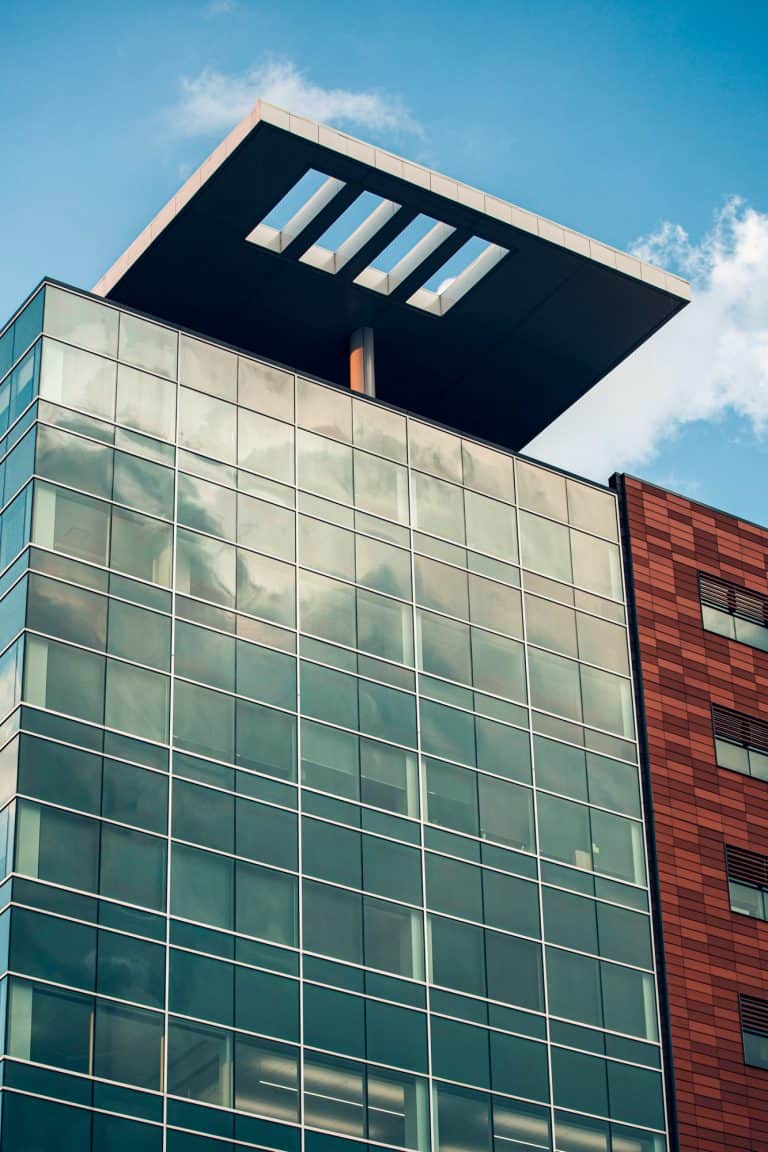 a high rise glass building in cedar rapids under a blue sky