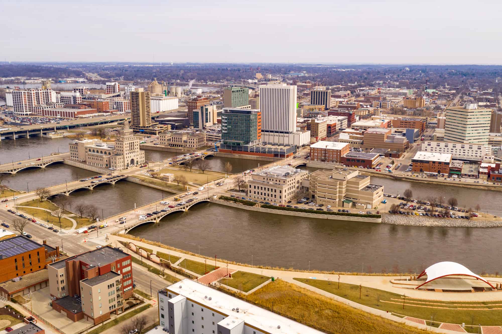 a birds eye view of cedar rapids and the riverfront with bridges and buildings along the waterfront, the breweries in cedar rapids, iowa are a must-visit while in the area