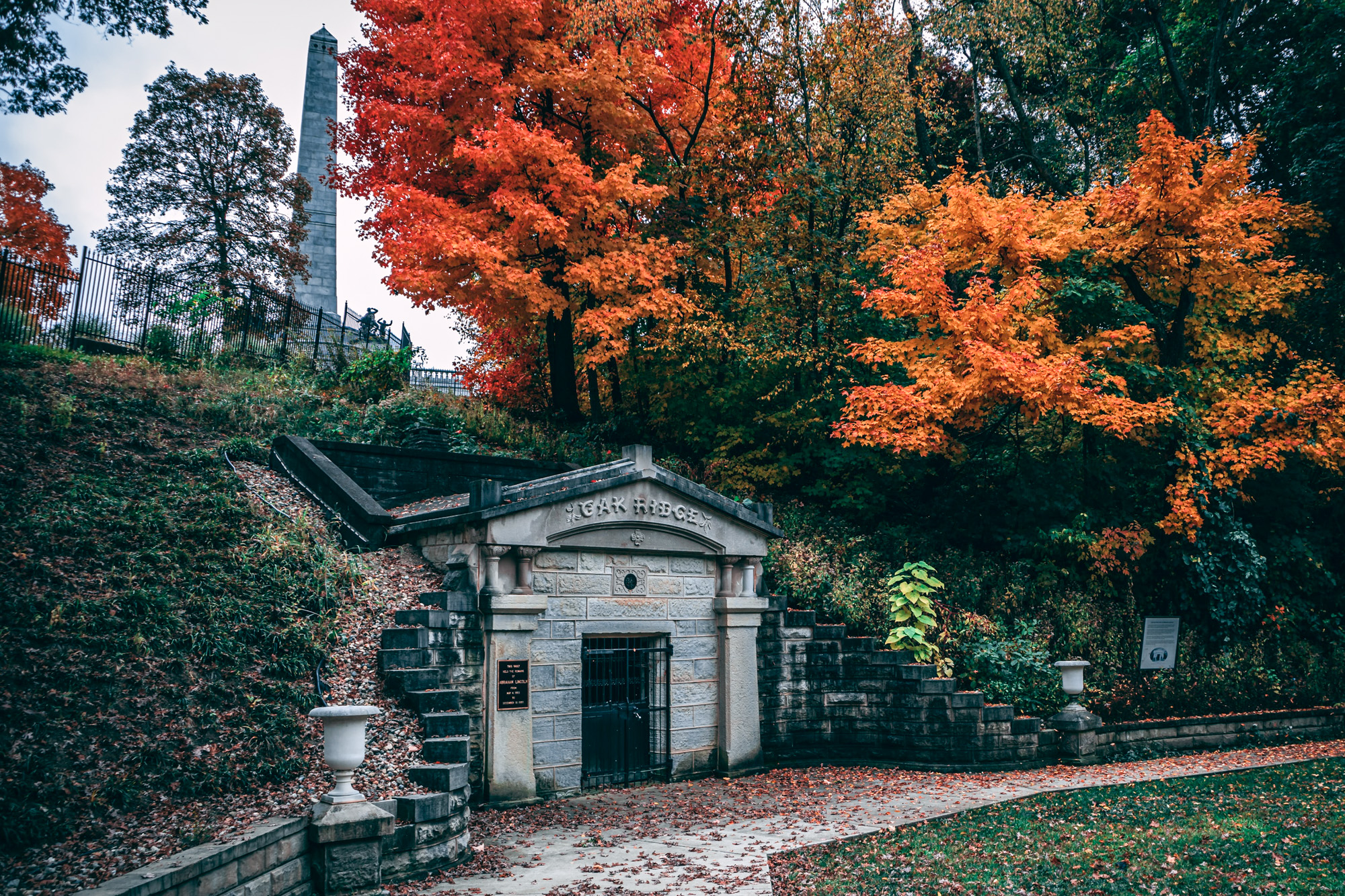 oak ridge cemetery in the fall with orange and red trees and a masoleum