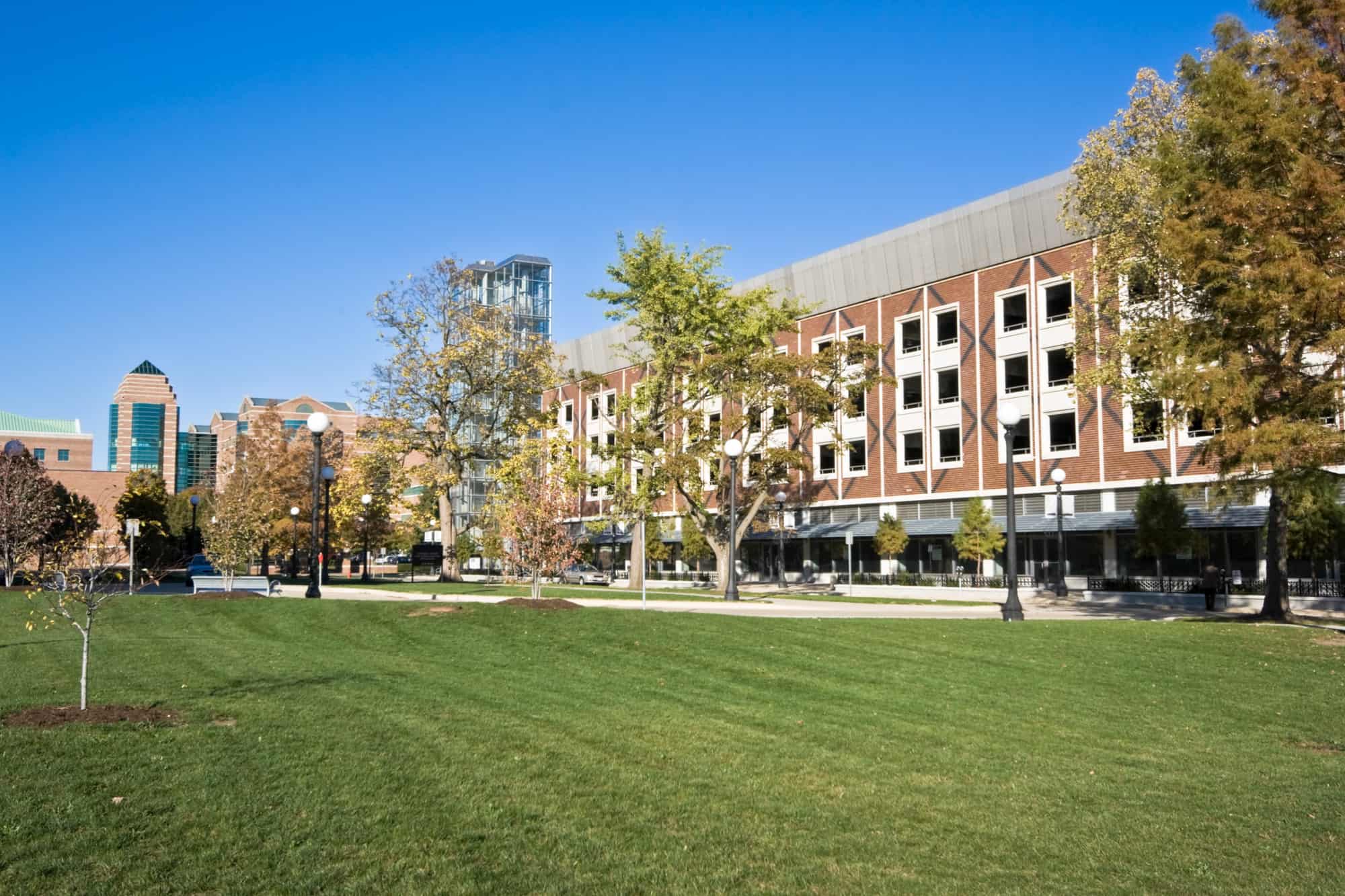 buildings on the campus of university of illinois sit behind a grassy lawn with green trees, you are welcome to check out the campus while visiting the breweries in champaign, il
