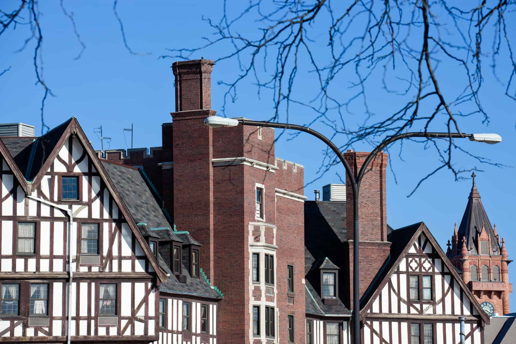 german style architecture with white front buildings with wood plank decoration along with brick buildings