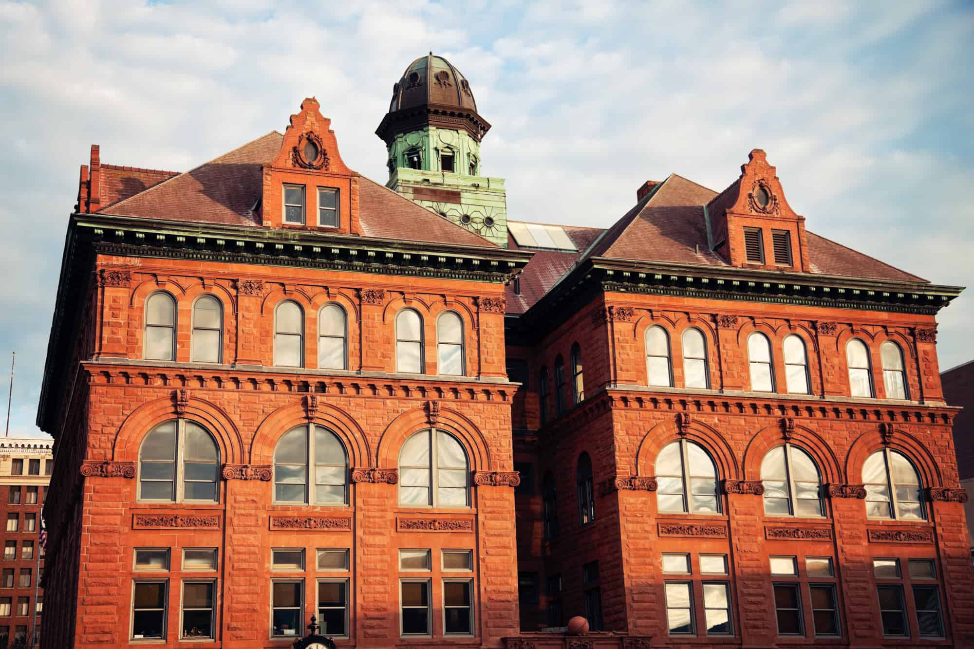 a brick building with golden light shining on its front in peoria, il