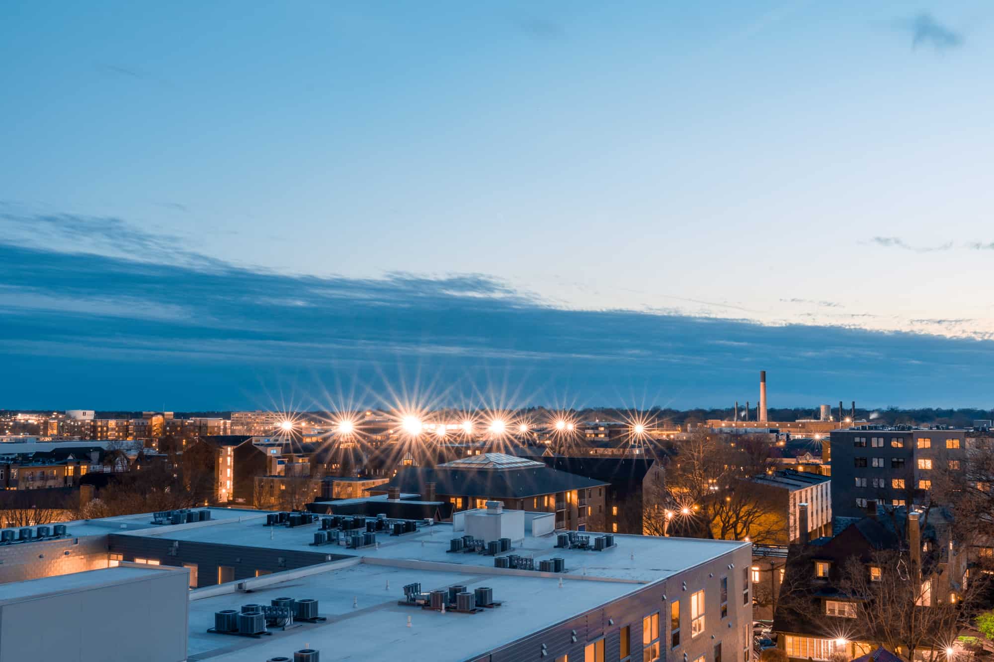 a birds eye view from above shows the university of illinois buildings at dusk under a partially cloudy sky