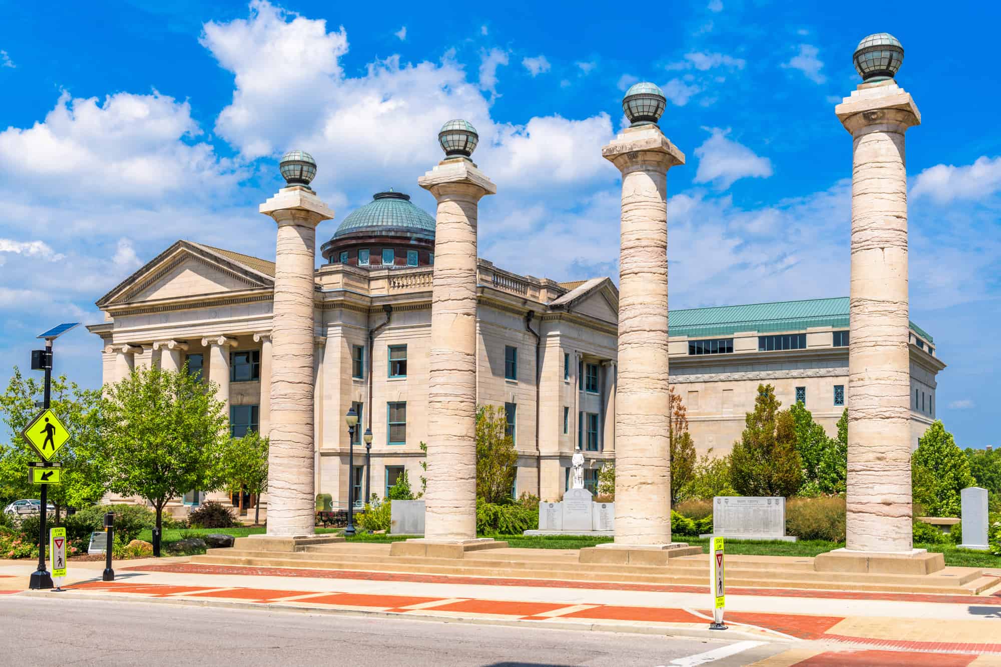 boone county courthouse with pillars out front under a blue sunny sky